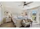 Bedroom with a ceiling fan, wood-look flooring, and doors to an outdoor area at 4744 Snook Se Dr, St Petersburg, FL 33705