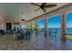 Inviting outdoor veranda with ceiling fans, multiple seating arrangements and ocean views at 4744 Snook Se Dr, St Petersburg, FL 33705