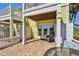 Charming patio area featuring brick pavers, a comfortable chair, and convenient access to the outdoors at 4744 Snook Se Dr, St Petersburg, FL 33705