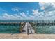 Picturesque view of a wooden pier over sparkling blue water at 4744 Snook Se Dr, St Petersburg, FL 33705