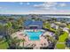 Aerial view of the community pool with lounge chairs, surrounded by lush landscaping and manicured grounds at 4744 Snook Se Dr, St Petersburg, FL 33705