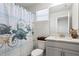 Bathroom featuring a turtle-themed shower curtain, white vanity with granite countertop, and framed mirror at 5286 Neil Dr, St Petersburg, FL 33714