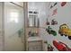 Bathroom featuring a shower with glass doors, single sink vanity, and decor at 5559 17Th N Ave, St Petersburg, FL 33710