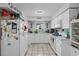 Bright kitchen featuring white cabinetry, tile floors and a window above the sink, providing natural light at 5559 17Th N Ave, St Petersburg, FL 33710