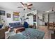 Cozy living room with a ceiling fan, area rug, and decorative shelves at 5559 17Th N Ave, St Petersburg, FL 33710