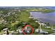 Aerial view of a home near the water, surrounded by lush greenery and other homes in a quiet neighborhood at 620 43Rd Street W Blvd, Palmetto, FL 34221