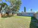 Spacious backyard featuring a lush lawn and a sturdy wooden fence, perfect for outdoor activities and privacy at 620 43Rd Street W Blvd, Palmetto, FL 34221
