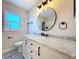 Elegant bathroom featuring a vanity with marble countertop, modern fixtures, and a decorative mirror at 620 43Rd Street W Blvd, Palmetto, FL 34221