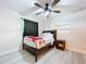 Stylish bedroom with a ceiling fan, dark curtains, and a full sized bed with a nightstand at 620 43Rd Street W Blvd, Palmetto, FL 34221