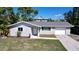 Charming single-story home featuring a well-maintained front yard and attached one car garage at 620 43Rd Street W Blvd, Palmetto, FL 34221