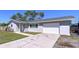 Street view of single story home with grey paint, white trim, and attached one car garage at 620 43Rd Street W Blvd, Palmetto, FL 34221