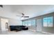 An expansive living room featuring ceiling fan, window with blinds, and door to the backyard at 620 43Rd Street W Blvd, Palmetto, FL 34221