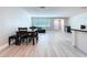 Bright living space featuring an open floorplan, dining set, and modern flooring at 620 43Rd Street W Blvd, Palmetto, FL 34221