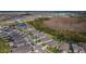 An aerial view of a new neighborhood reveals modern homes, lush landscaping, and inviting community lakes and green spaces at 7580 Pool Compass Loop, Wesley Chapel, FL 33545