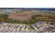 An aerial shot of a new residential development featuring modern homes, green spaces, and a scenic view of surrounding areas at 7580 Pool Compass Loop, Wesley Chapel, FL 33545