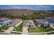 Aerial view of a well-maintained home with manicured lawn and mature trees at 7580 Pool Compass Loop, Wesley Chapel, FL 33545