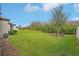 Expansive backyard with lush green lawn, mature trees, and natural surroundings at 7580 Pool Compass Loop, Wesley Chapel, FL 33545