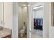 Powder room adjacent to walk-in closet with adjacent toilet at 7580 Pool Compass Loop, Wesley Chapel, FL 33545
