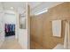 Bathroom features a large glass-enclosed tiled shower with towel rack and window at 7580 Pool Compass Loop, Wesley Chapel, FL 33545
