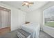 Bright bedroom with a ceiling fan, a closet and a window for natural light at 7580 Pool Compass Loop, Wesley Chapel, FL 33545