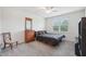 Neutral bedroom features a ceiling fan and a dresser at 7580 Pool Compass Loop, Wesley Chapel, FL 33545