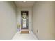 Cozy home entrance with decorative wreath and welcome mat at 7580 Pool Compass Loop, Wesley Chapel, FL 33545