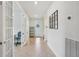 Hallway featuring tile flooring, french doors and a decorative glass door at 7580 Pool Compass Loop, Wesley Chapel, FL 33545
