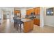 Kitchen with island seating and stainless appliances, open view to dining area at 7580 Pool Compass Loop, Wesley Chapel, FL 33545