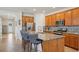 Kitchen with island seating and stainless appliances, open view to dining area at 7580 Pool Compass Loop, Wesley Chapel, FL 33545