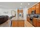 Bright open kitchen with stainless appliances, granite counters, large island, breakfast bar and view into the living room at 7580 Pool Compass Loop, Wesley Chapel, FL 33545