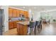 Spacious kitchen features wood cabinets, granite counters, tile backsplash, and stainless steel appliances at 7580 Pool Compass Loop, Wesley Chapel, FL 33545