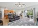 Open-concept living room showing kitchen, comfortable seating, and sliding doors to outdoor space at 7580 Pool Compass Loop, Wesley Chapel, FL 33545