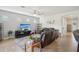 Bright living room with neutral walls, tile flooring, comfortable seating, and large entertainment center at 7580 Pool Compass Loop, Wesley Chapel, FL 33545
