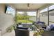 Relax on this screened lanai with a fire pit and serene backyard views at 7580 Pool Compass Loop, Wesley Chapel, FL 33545