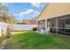 Private backyard with lush green grass, a patio, and a secure white fence for added privacy at 8315 Moccasin Trail Dr, Riverview, FL 33578