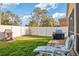 Lush backyard with a well-maintained lawn, privacy fence, and outdoor lounge area at 8315 Moccasin Trail Dr, Riverview, FL 33578
