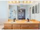Bathroom with double sinks, a large mirror, and a glass shower at 8315 Moccasin Trail Dr, Riverview, FL 33578