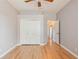This bedroom features a closet, hardwood floors, neutral paint, and open access to the hallway at 8315 Moccasin Trail Dr, Riverview, FL 33578