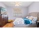 Comfortable bedroom features a queen bed, wood floors, and a large dresser at 8315 Moccasin Trail Dr, Riverview, FL 33578