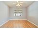 Empty bedroom featuring hardwood floors and a large window at 8315 Moccasin Trail Dr, Riverview, FL 33578