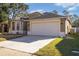Exterior front elevation of home with a two car garage and nice yard at 8315 Moccasin Trail Dr, Riverview, FL 33578