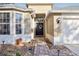 Exterior front shot of home featuring well manicured rock and brick landscaping and a black front door at 8315 Moccasin Trail Dr, Riverview, FL 33578