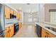 Kitchen with a breakfast nook, wooden cabinets, and black appliances at 8315 Moccasin Trail Dr, Riverview, FL 33578