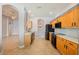 Bright kitchen with wooden cabinets, tile floors, and black appliances at 8315 Moccasin Trail Dr, Riverview, FL 33578