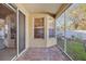 Covered patio with brick flooring and screened enclosure leading to backyard at 8315 Moccasin Trail Dr, Riverview, FL 33578