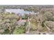 Aerial view of the lake, showcasing the property, mature trees, and serene surroundings at 8922 Donna Lu Dr, Odessa, FL 33556