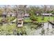 Backyard view with a dock overlooking a lush pond filled with water lilies and mature trees at 8922 Donna Lu Dr, Odessa, FL 33556