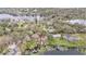 Stunning aerial view of lakefront homes with private docks surrounded by lush, mature trees and tranquil waters at 8922 Donna Lu Dr, Odessa, FL 33556