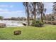 Picturesque lakeside backyard with a dock and lush landscaping creating a tranquil setting at 8922 Donna Lu Dr, Odessa, FL 33556