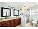 Bathroom featuring double sinks, granite vanity, and a glass enclosed shower at 8922 Donna Lu Dr, Odessa, FL 33556
